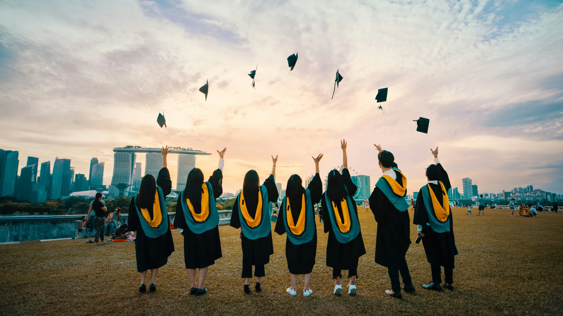 Graduates celebrating together outdoors